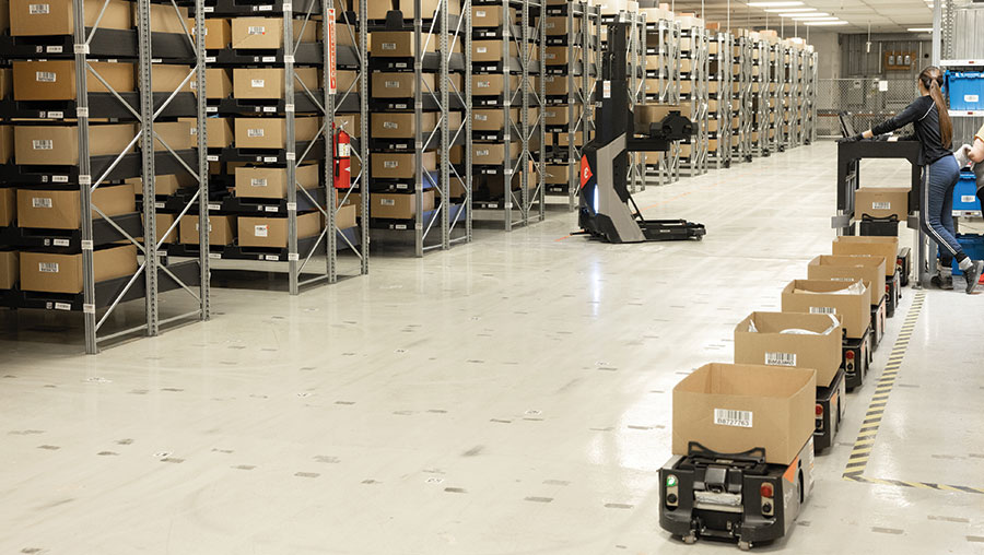 Robots are queued to deliver cartons to be picked to the workstation. After, they will be returned to storage.