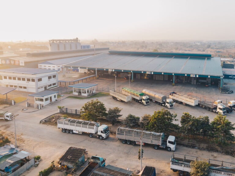 Aerial view of a fulfillment warehouse with trucks at the loading docks